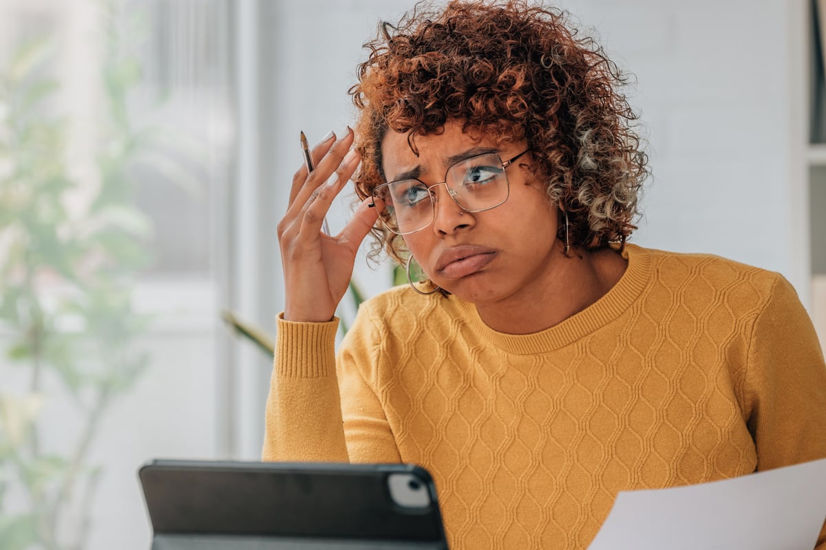 woman or client at home stressed or overwhelmed with expenses and bills