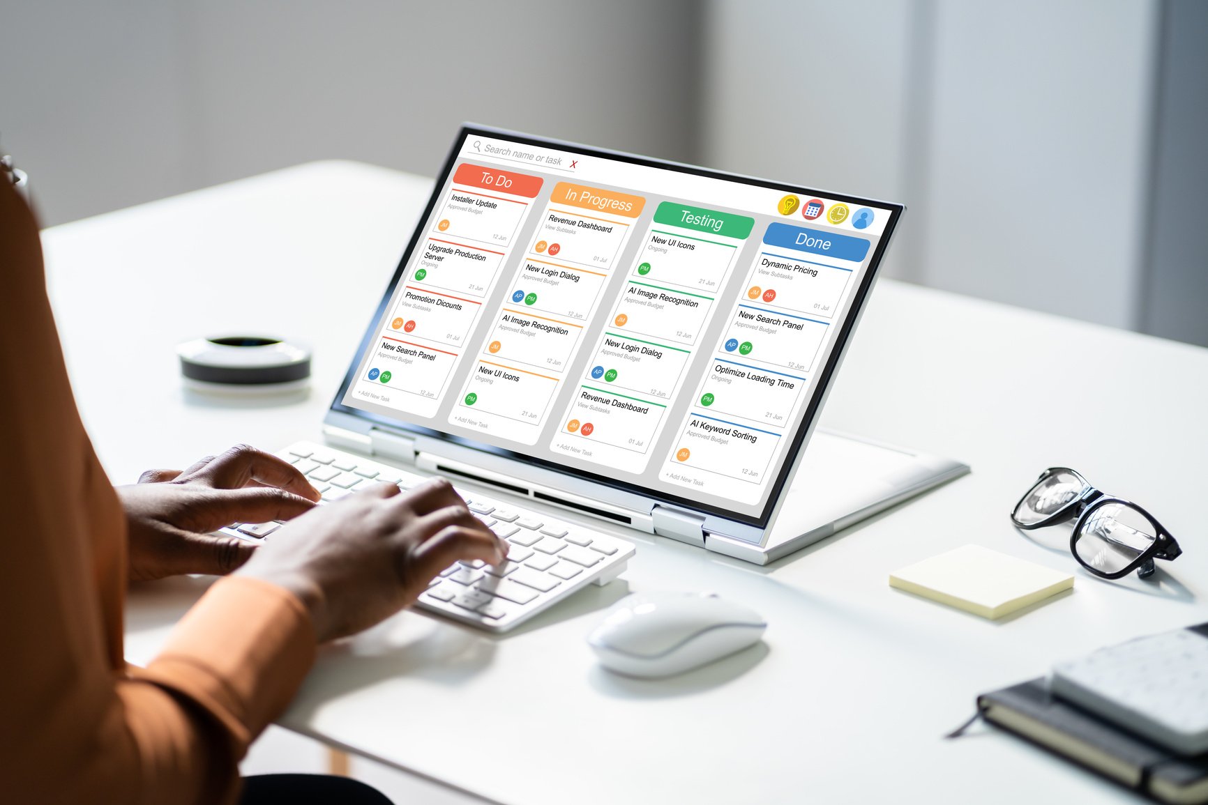 a project manager working at a desk making sure that every project aligns with the needs and goals of the woman-owned business. 